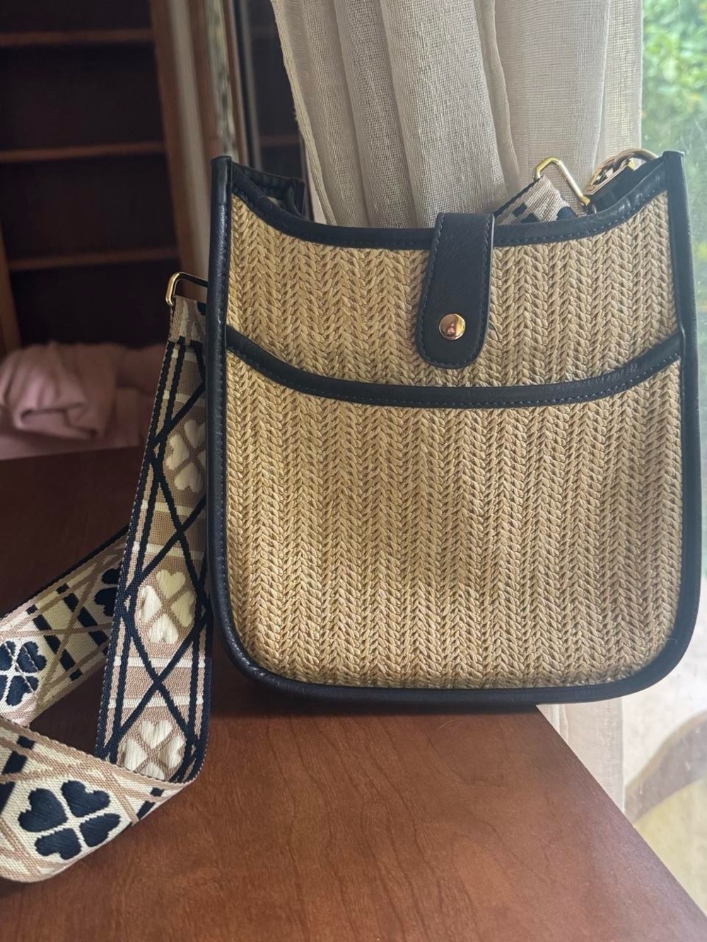 Woven Straw Crossbody Bag with Black Trim and Patterned Strap